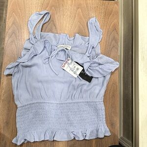 Paper and crane light blue top.